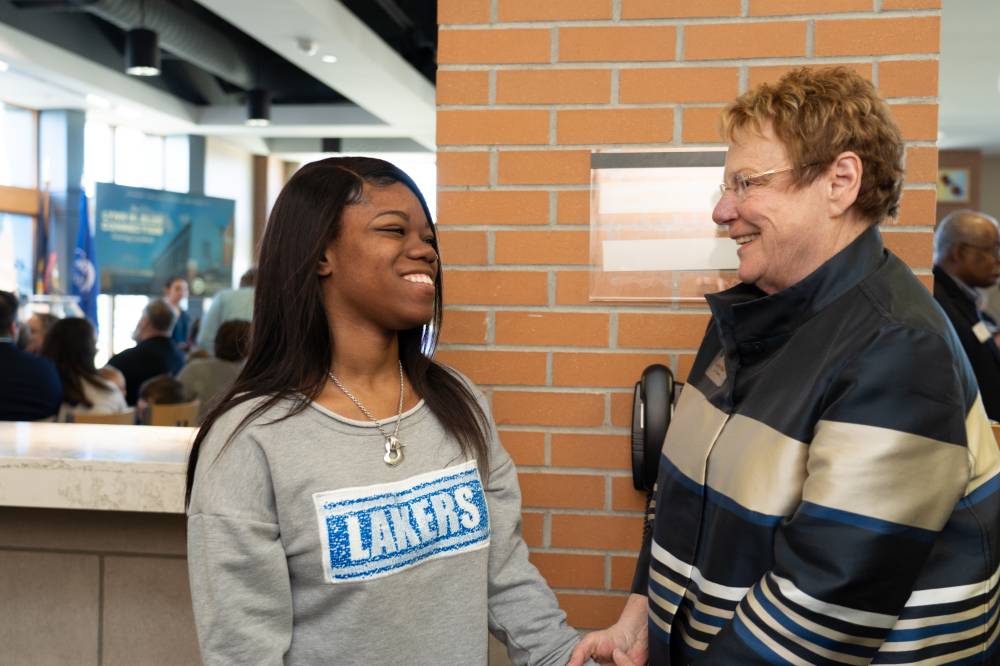 Lynn Blue speaking with a student at the Lynn M. Blue Connection Naming Ceremony